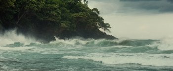 Movie still from “Old” (2021), directed by M. Night Shyamalan – A large body of water with trees on top of it; Extreme Wide shot, High angle