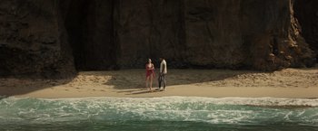 Movie still from “Old” (2021), directed by M. Night Shyamalan – Two people standing on the beach near the water; Extreme Wide shot, High angle
