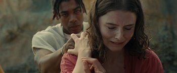 Movie still from “Old” (2021), directed by M. Night Shyamalan – A man and a woman are holding hands and crying; Close Up shot, Over the shoulder angle