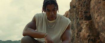 Movie still from “Old” (2021), directed by M. Night Shyamalan – A person sitting on the ground; Close Up shot, Low angle