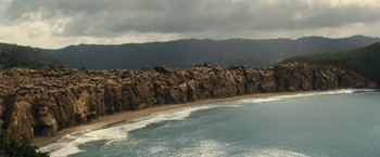 Movie still from “Old” (2021), directed by M. Night Shyamalan – A view of the ocean from a cliff; Extreme Wide shot, High angle