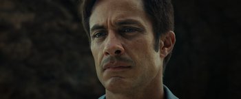 Movie still from “Old” (2021), directed by M. Night Shyamalan – A person with a mustache; Close Up shot, Low angle