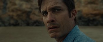 Movie still from “Old” (2021), directed by M. Night Shyamalan – A man's face in a blue shirt; Close Up shot, Low angle