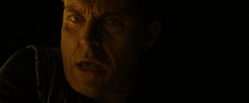 Movie still from “Old” (2021), directed by M. Night Shyamalan – A man's face in the dark; Close Up shot, Low angle