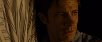 Movie still from “Old” (2021), directed by M. Night Shyamalan – A man's face in the dark; Close Up shot, High angle