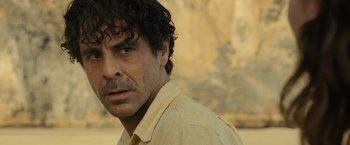 Movie still from “Old” (2021), directed by M. Night Shyamalan – A person wearing a yellow shirt; Close Up shot, Over the shoulder angle