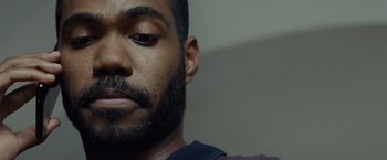 Movie still from “Old” (2021), directed by M. Night Shyamalan – A man with a beard; Extreme Close Up shot, Over the shoulder angle