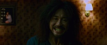 Movie still from “Oldboy” (2003), directed by Park Chan-wook – A person with long black hair; Close Up shot, High angle