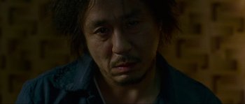 Movie still from “Oldboy” (2003), directed by Park Chan-wook – A person wearing a jacket; Close Up shot, Low angle