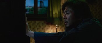 Movie still from “Oldboy” (2003), directed by Park Chan-wook – A man is pointing at a television screen; Close Up shot, Low angle