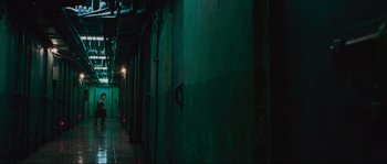 Movie still from “Oldboy” (2003), directed by Park Chan-wook – A dark hallway with a light hanging from the side of the wall; Wide shot, High angle
