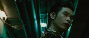 Movie still from “Oldboy” (2003), directed by Park Chan-wook – A person wearing a colorful shirt; Close Up shot, Low angle