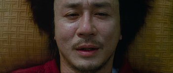 Movie still from “Oldboy” (2003), directed by Park Chan-wook – A man with long hair; Extreme Close Up shot, High angle