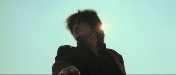 Movie still from “Oldboy” (2003), directed by Park Chan-wook – A man standing in front of the sun; Close Up shot, Low angle