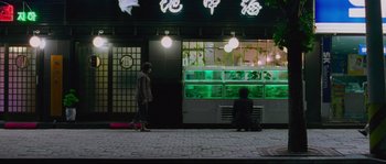 Movie still from “Oldboy” (2003), directed by Park Chan-wook – Two people sitting in front of an aquarium at night; Wide shot, Over the shoulder angle