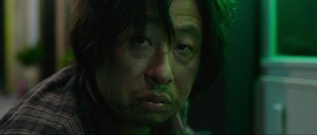 Movie still from “Oldboy” (2003), directed by Park Chan-wook – A person with green hair; Close Up shot, Low angle
