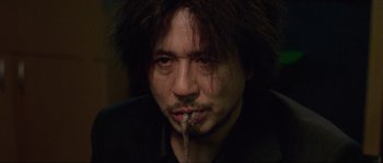 Movie still from “Oldboy” (2003), directed by Park Chan-wook – A person with long black hair; Close Up shot, Low angle