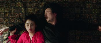 Movie still from “Oldboy” (2003), directed by Park Chan-wook – A man and a girl sleeping on a bed; Medium shot, Overhead angle