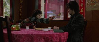 Movie still from “Oldboy” (2003), directed by Park Chan-wook – A man and a woman sitting at a table with a plate of food in front of them; Medium shot, Over the shoulder angle