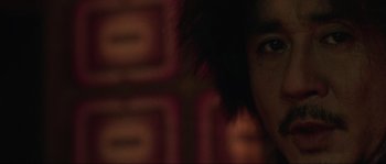 Movie still from “Oldboy” (2003), directed by Park Chan-wook – A man with a black afro is looking at the camera; Extreme Close Up shot, Low angle