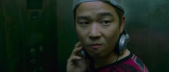 Movie still from “Oldboy” (2003), directed by Park Chan-wook – A man wearing a hat and talking on a cell phone; Close Up shot, Low angle