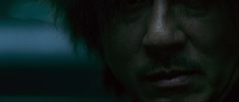 Movie still from “Oldboy” (2003), directed by Park Chan-wook – A man's face in the dark; Extreme Close Up shot, Low angle