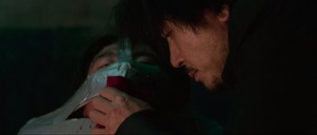 Movie still from “Oldboy” (2003), directed by Park Chan-wook – A man with a bandage on his face and another man with a bandage on his mouth; Close Up shot, Over the shoulder angle