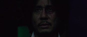 Movie still from “Oldboy” (2003), directed by Park Chan-wook – A person wearing a shirt and tie; Close Up shot, Low angle