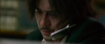 Movie still from “Oldboy” (2003), directed by Park Chan-wook – A person holding a cell phone to his ear; Close Up shot, Low angle