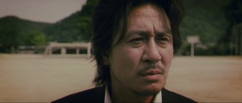 Movie still from “Oldboy” (2003), directed by Park Chan-wook – A person with long hair; Close Up shot, Low angle