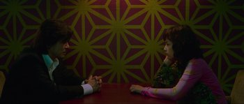 Movie still from “Oldboy” (2003), directed by Park Chan-wook – A man and a woman sitting at a table talking to each other; Medium shot, High angle