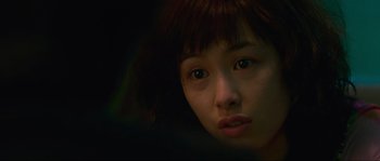 Movie still from “Oldboy” (2003), directed by Park Chan-wook – A young woman's face in the dark; Close Up shot, Over the shoulder angle