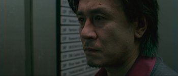 Movie still from “Oldboy” (2003), directed by Park Chan-wook – A person wearing a suit and tie; Close Up shot, Low angle