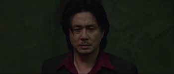 Movie still from “Oldboy” (2003), directed by Park Chan-wook – A person with long black hair; Close Up shot, Low angle