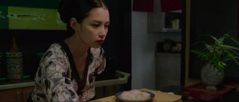 Movie still from “Oldboy” (2003), directed by Park Chan-wook – A woman sitting at a table with a plate of food in front of her; Close Up shot, High angle