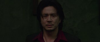Movie still from “Oldboy” (2003), directed by Park Chan-wook – A person with long black hair; Close Up shot, Low angle