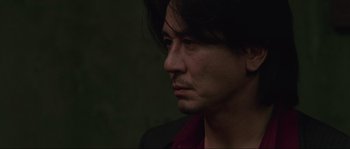 Movie still from “Oldboy” (2003), directed by Park Chan-wook – A person with long black hair; Close Up shot, Low angle