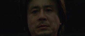 Movie still from “Oldboy” (2003), directed by Park Chan-wook – A man's face with a beard; Extreme Close Up shot, Low angle