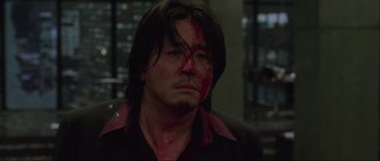 Movie still from “Oldboy” (2003), directed by Park Chan-wook – A person with blood on his face; Close Up shot, High angle