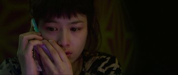 Movie still from “Oldboy” (2003), directed by Park Chan-wook – A young woman sitting in front of a wall; Close Up shot, High angle