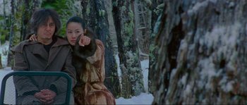 Movie still from “Oldboy” (2003), directed by Park Chan-wook – A woman in a fur coat pointing at the camera; Medium shot, Over the shoulder angle