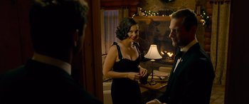 Movie still from “Olympus Has Fallen” (2013), directed by Antoine Fuqua – A woman in a black dress standing next to a man in front of a fireplace; Medium shot, Over the shoulder angle