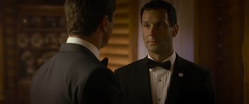 Movie still from “Olympus Has Fallen” (2013), directed by Antoine Fuqua – A man in a suit and a bow tie talking to another man in a suit and a bow tie; Close Up shot, Over the shoulder angle