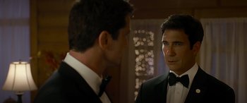 Movie still from “Olympus Has Fallen” (2013), directed by Antoine Fuqua – A man in a suit and tie looking at another man in a tuxedo; Close Up shot, Over the shoulder angle