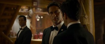 Movie still from “Olympus Has Fallen” (2013), directed by Antoine Fuqua – A man in a suit and a bow tie talking to another man in a suit; Close Up shot, Over the shoulder angle