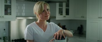 Movie still from “Olympus Has Fallen” (2013), directed by Antoine Fuqua – A woman in a white shirt is holding something in her hand; Close Up shot, Over the shoulder angle