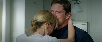 Movie still from “Olympus Has Fallen” (2013), directed by Antoine Fuqua – A man and a woman touching their faces together; Close Up shot, Over the shoulder angle