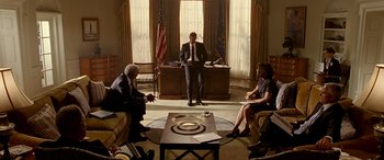 Movie still from “Olympus Has Fallen” (2013), directed by Antoine Fuqua – A group of people sitting in a living room; Wide shot, Low angle