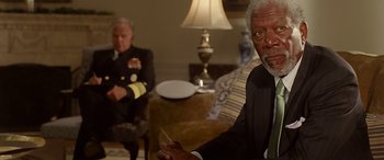 Movie still from “Olympus Has Fallen” (2013), directed by Antoine Fuqua – Two men sitting in a living room next to each other; Medium shot, Over the shoulder angle