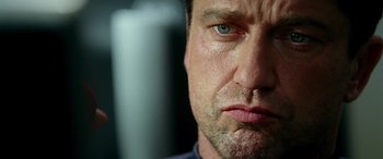 Movie still from “Olympus Has Fallen” (2013), directed by Antoine Fuqua – A man's face with a blue - green eye; Close Up shot, Low angle